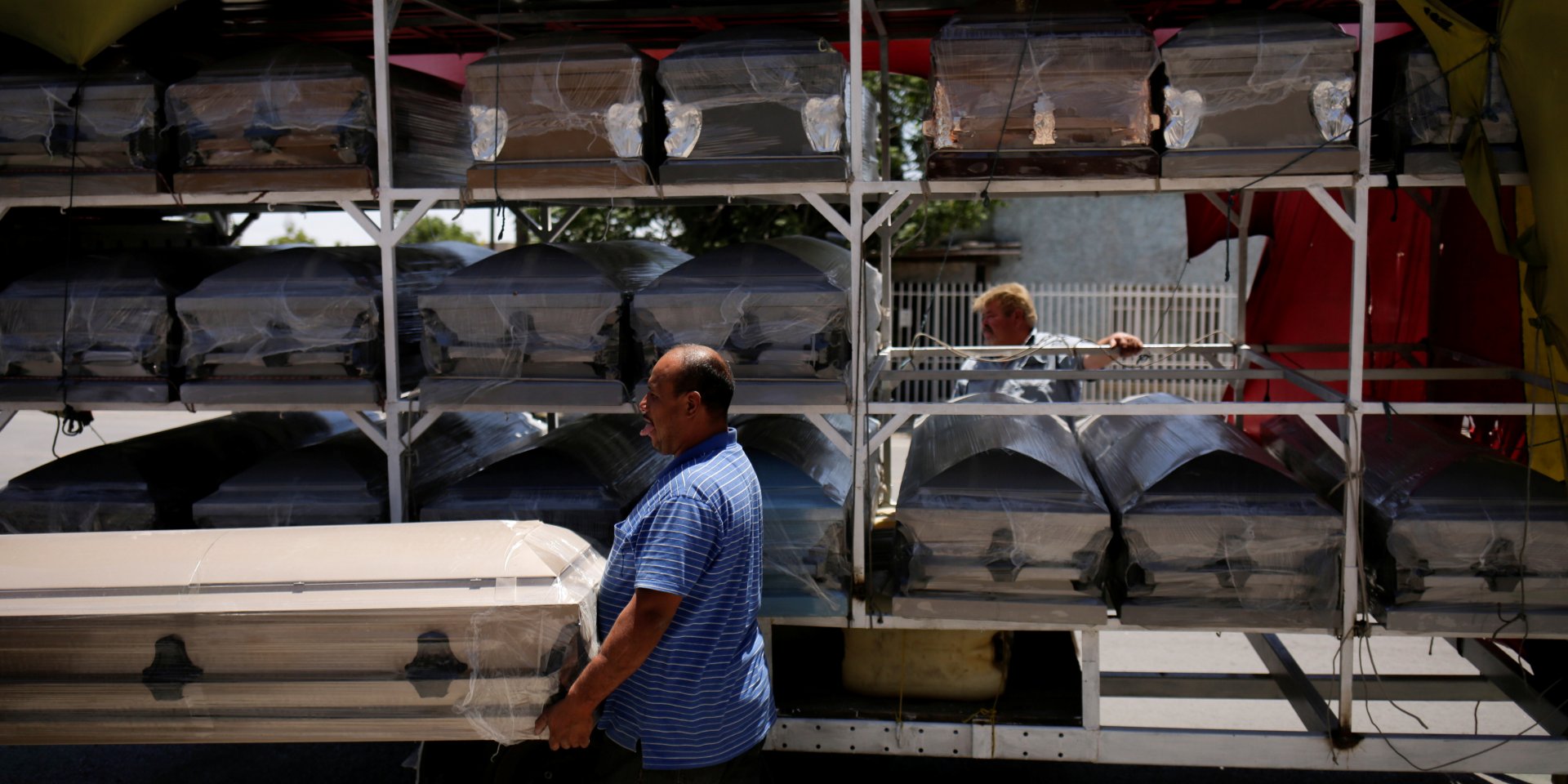 Продавцы несут гроб, чтобы доставить его в похоронное бюро, Мексика (Фото: REUTERS/Jose Luis Gonzalez)