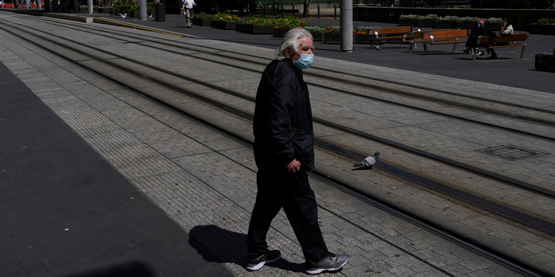 Мужчина в маске на улице города (Фото: REUTERS/Loren Elliott)