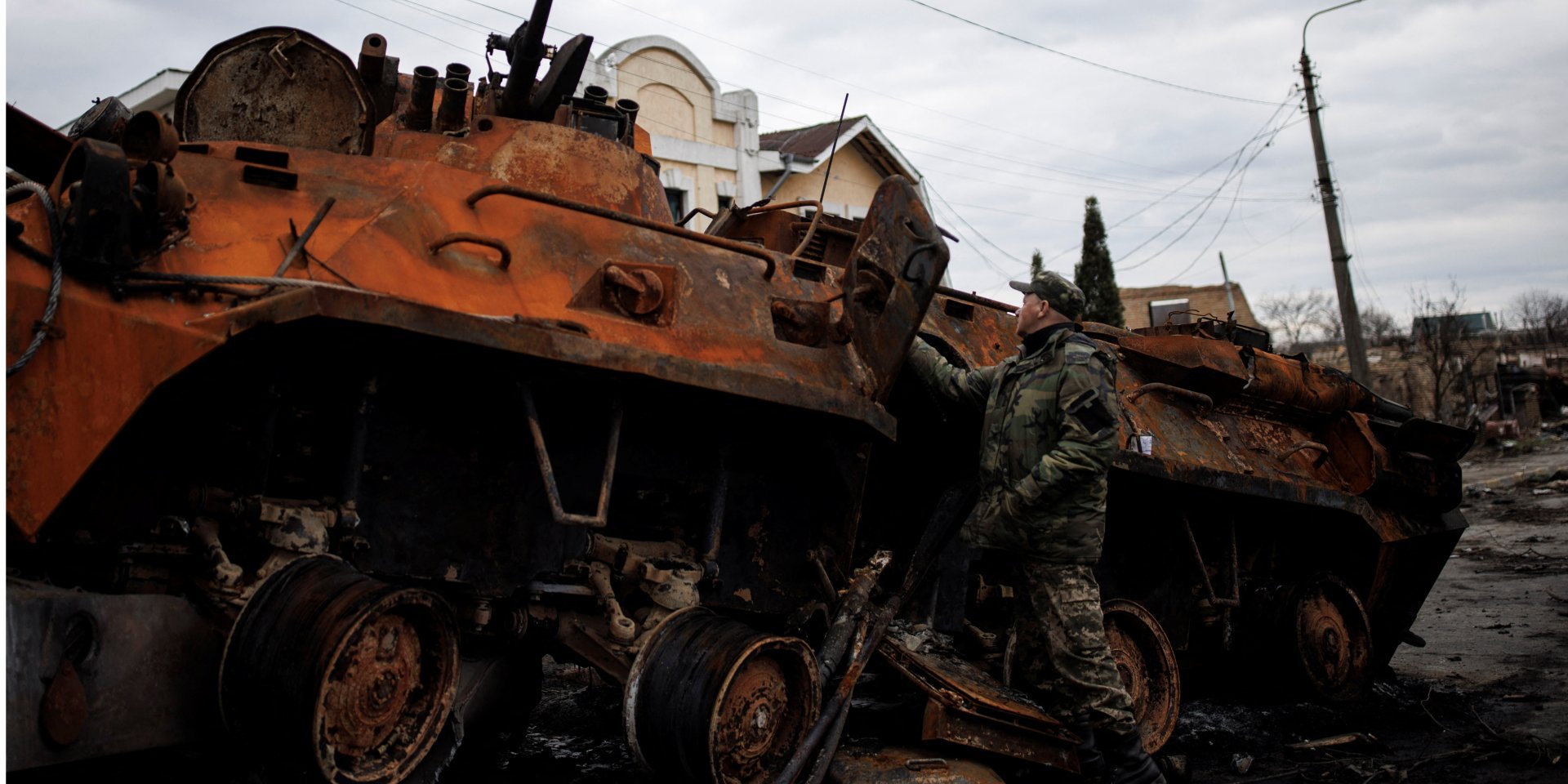 A Ukrainian serviceman inspects destroyed Russian military vehicle in Bucha, Kyiv Oblast (Photo: REUTERS/Alkis Konstantinidis)