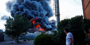 Харків'янин дивиться на наслідки російського удару по Епіцентру (Фото:REUTERS/Valentyn Ogirenko)