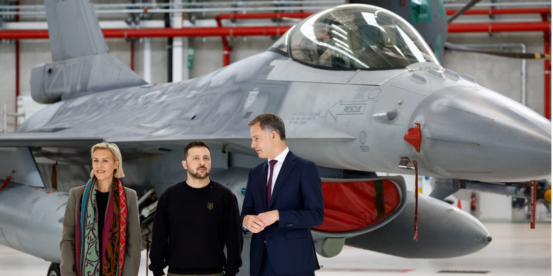 Ukrainian President Volodymyr Zelenskyy, Belgian Prime Minister Alexander De Croo, and Belgian Defense Minister Ludivine Dedonder stand near an F-16 at Melsbroek Air Base in Belgium on May 28, 2024. (Photo: REUTERS/Piroschka van de Wouw)