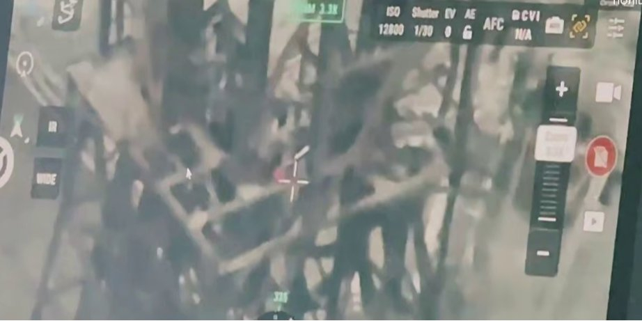 An occupier attempted to unfurl the tricolor over Toretsk by climbing a mine shaft tower. (Photo: Screenshot from video / Predator Brigade / Telegram)