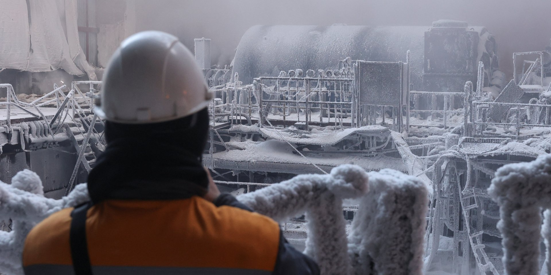 The energy worker is looking at the TPP damaged equipment, covered in ice, after the multiple Russian attack at a non-disclosed site, Jan. 21, 2026 (Photo: REUTERS/Roman Baluk)