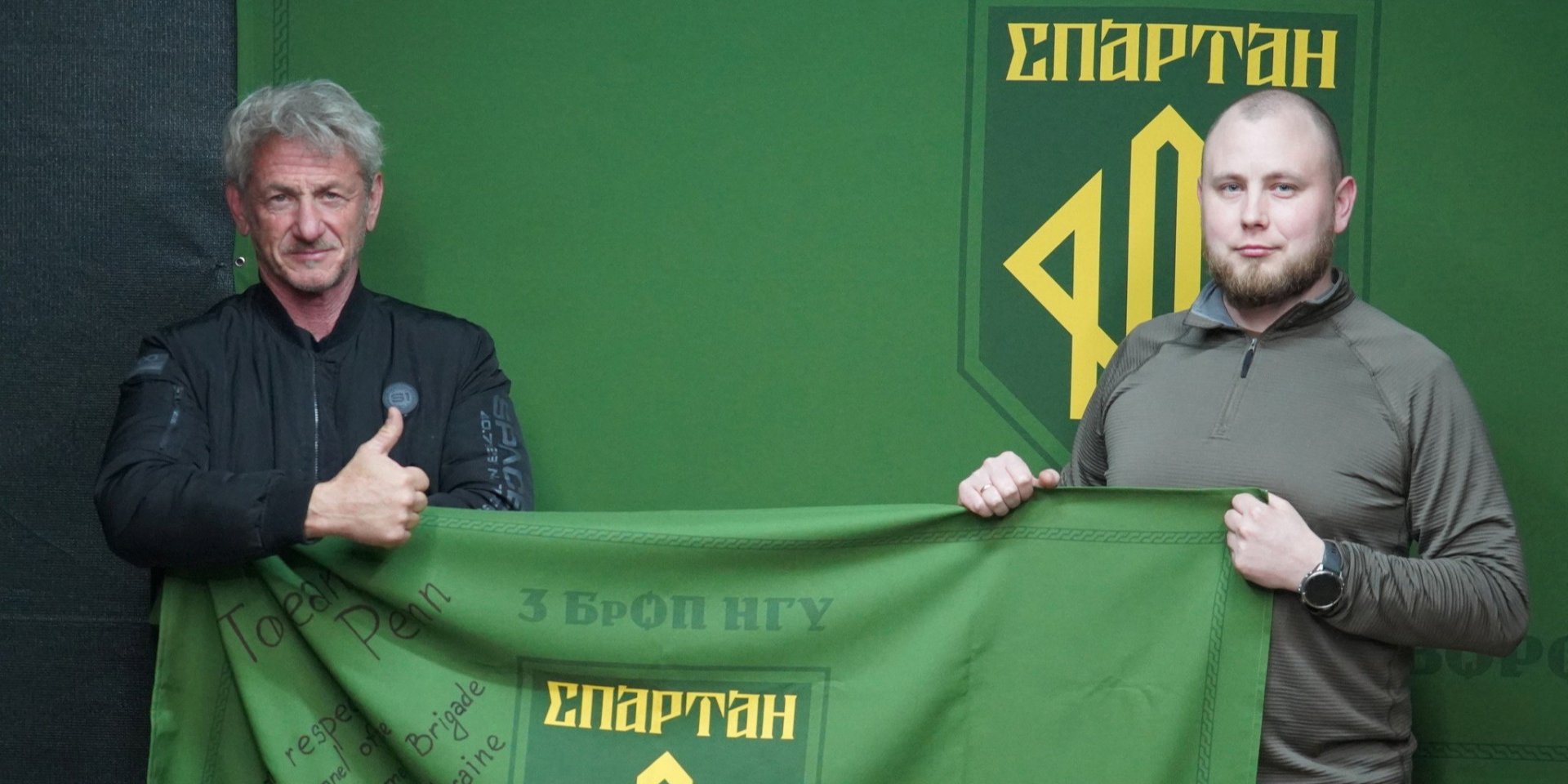 Actor Sean Penn meets a service member of the National Guard 3rd Operational 