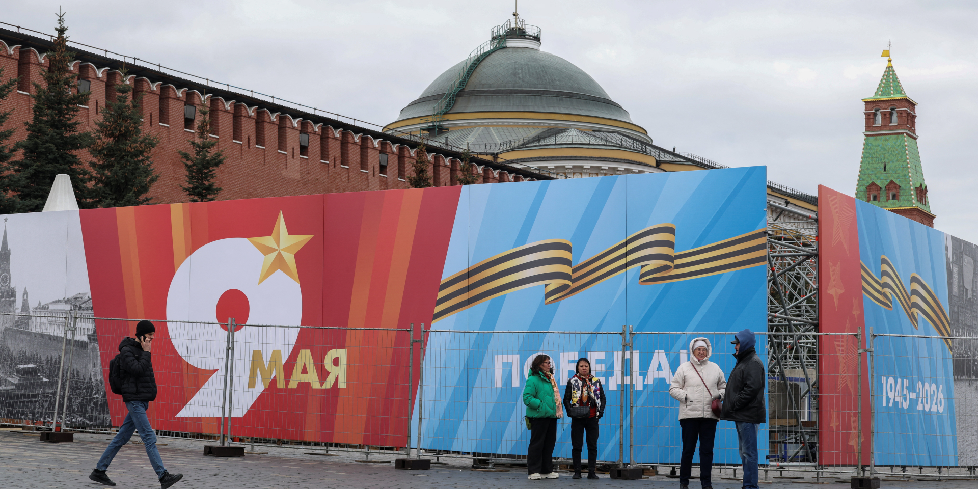People near a banner on Red Square in Moscow, Russia, ahead of Russia's 