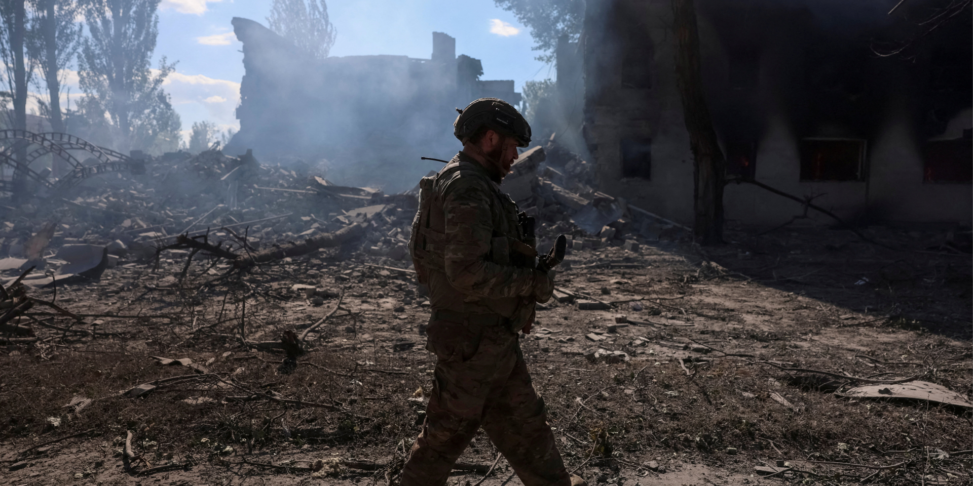 Ukrainian soldier in front of the destroyed buildings on Dobropillia, June 28, 2026 (Photo: REUTERS/Anatolii Stepanov)