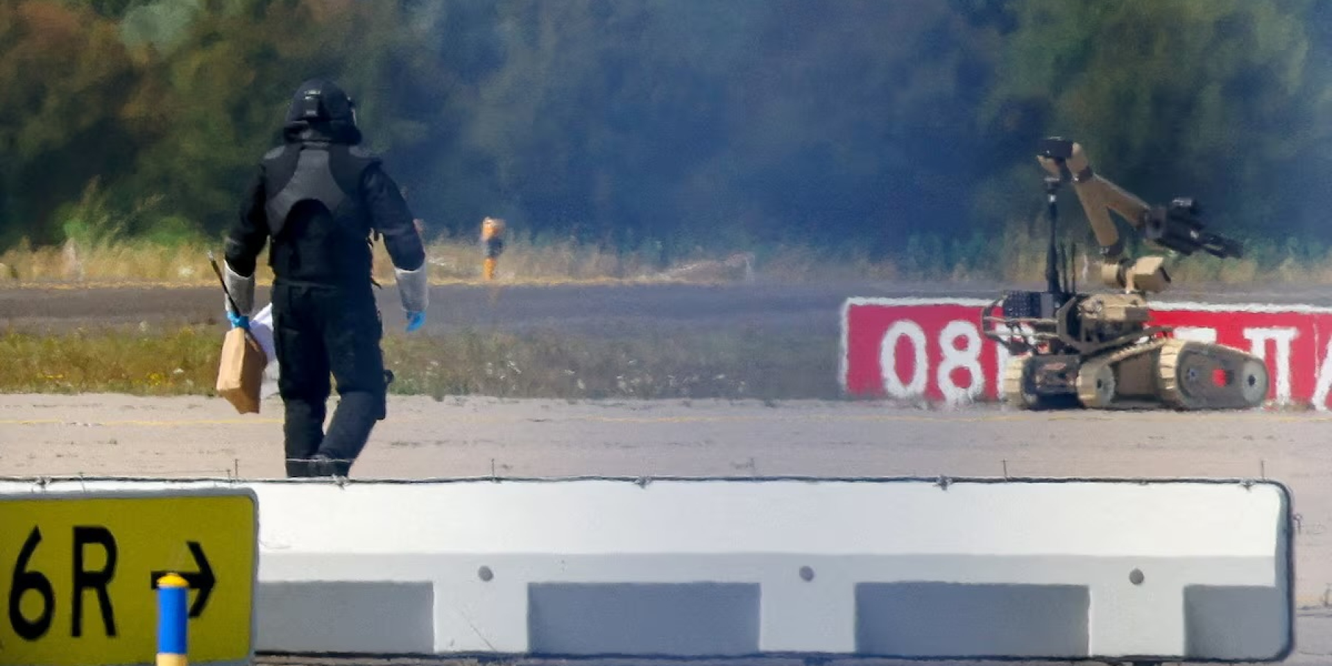 Bomb disposal experts use a specialized robot to inspect an explosive-laden drone discovered near the Leipzig Airport runway (Photo: REUTERS/Axel Schmidt)