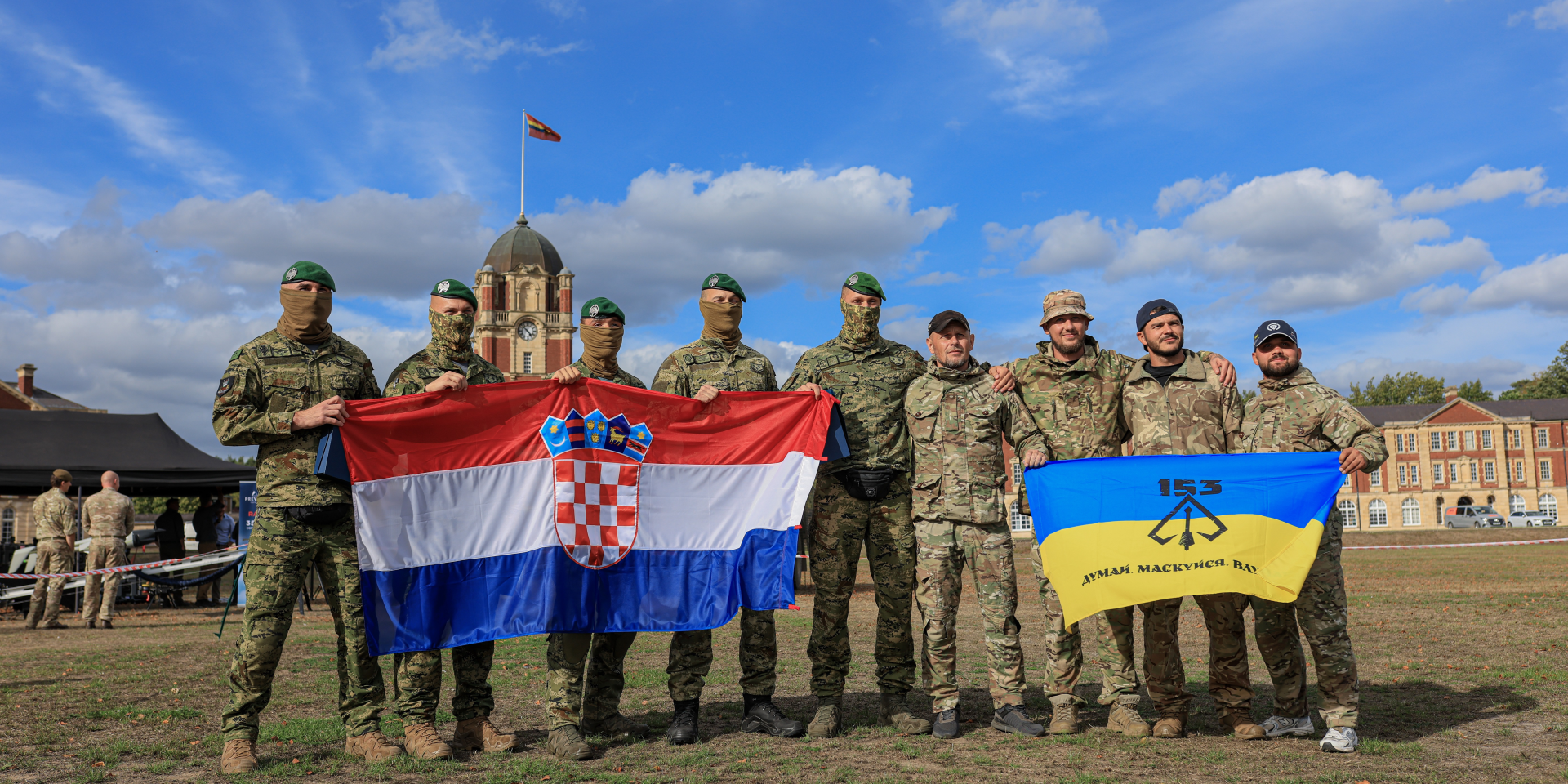 Ukrainian and Croatian military drone operators pose with their national flags during the international drone competition at the Royal Military Academy Sandhurst in England, September 2026. (Photo: The Federation of Technological Sport of Ukraine)