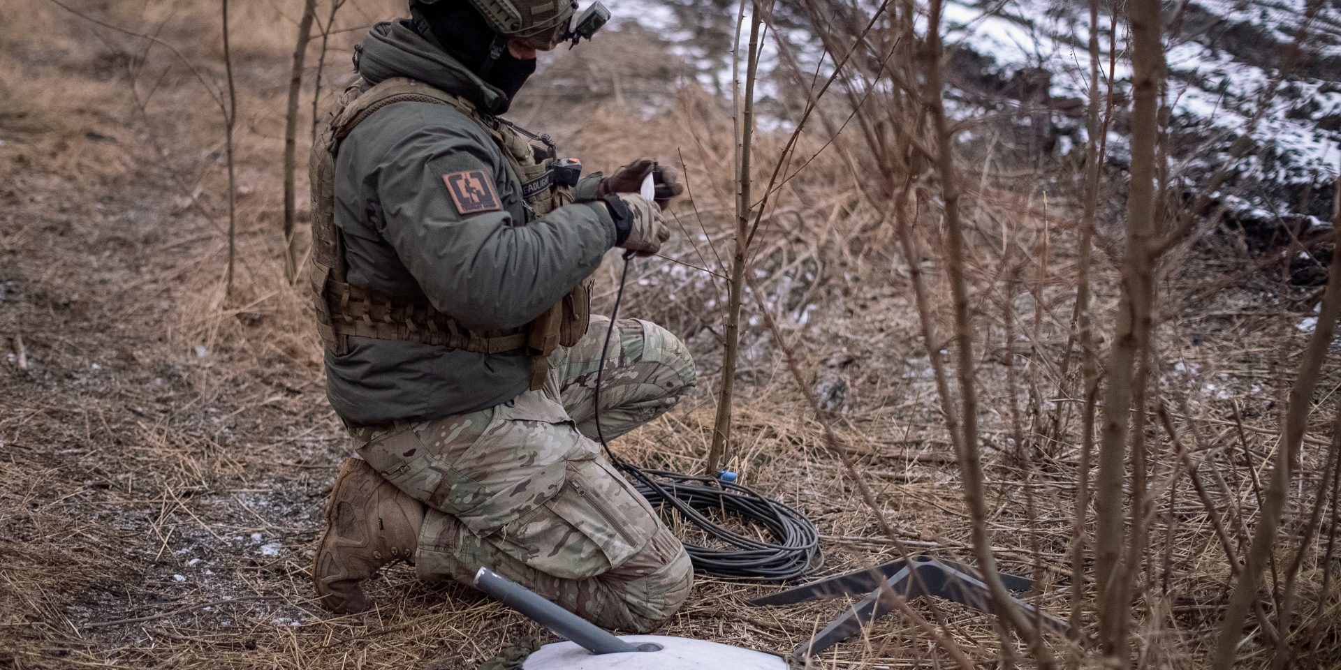 A Ukrainian serviceman sets up a Starlink terminal at his position on the front line near Avdiivka in February 2024 (Photo: REUTERS/Inna Varenytsia/File Photo)