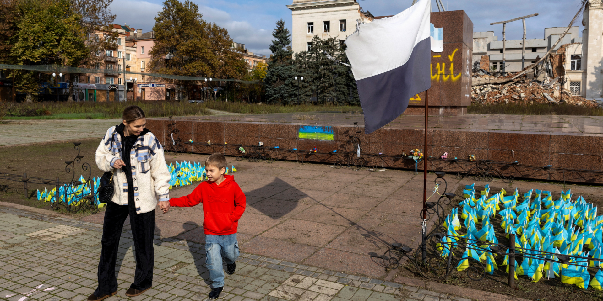 Kherson resident Natalia and her son Bohdan in the city’s central square near the Kherson Oblast Military Administration building, which was destroyed in a Russian strike, on Oct. 28, 2026. (Photo: REUTERS/Thomas Peter)