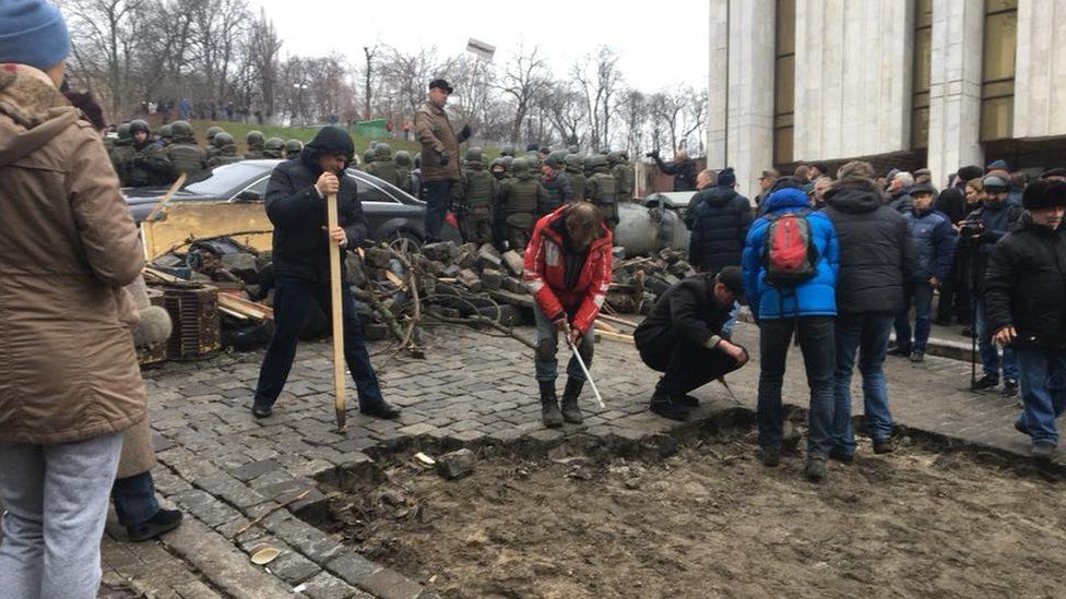 Сторонники Саакашвили разбирают мостовую возле Украинского дома (Фото: BBC)